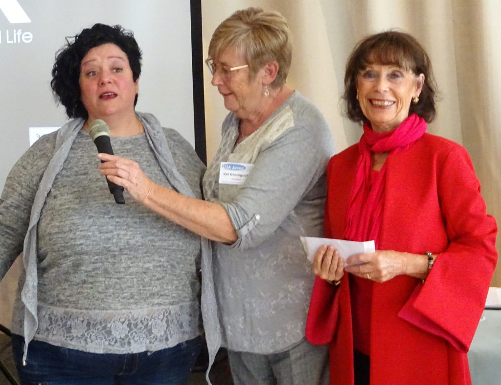 Our president, centre, presenting the cheque to charity representatives Carmen Alesanco and Marion Kenworthy